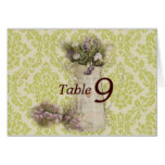 floral design in tin pitcher on green floral wallp card